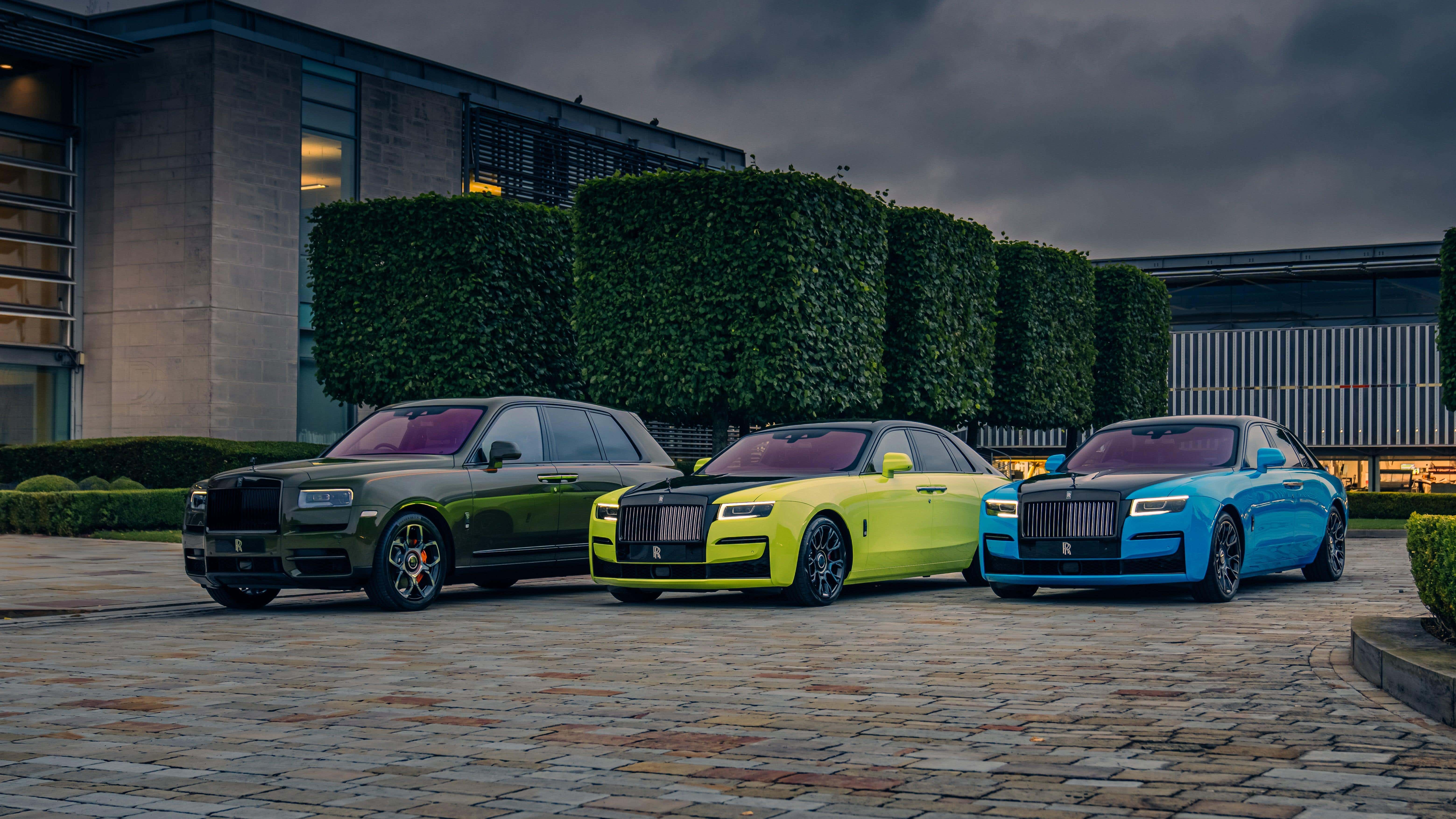 Une Rolls-Royce Cullinan et deux Rolls-Royce Ghost garées sur des pavés